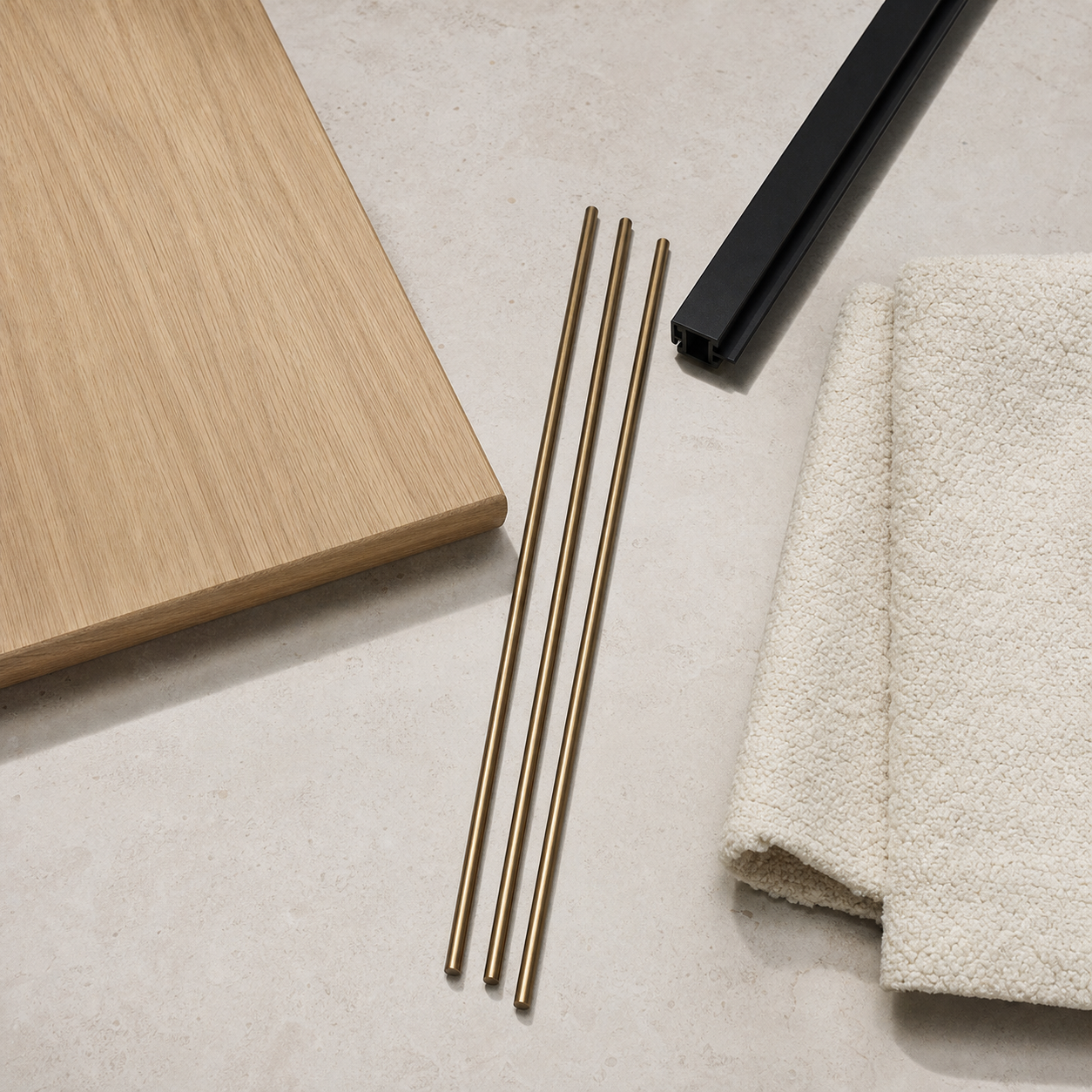 A material study of Koja's pale oak, satin-bronze rods, matte-black aluminum, and cream bouclé mat