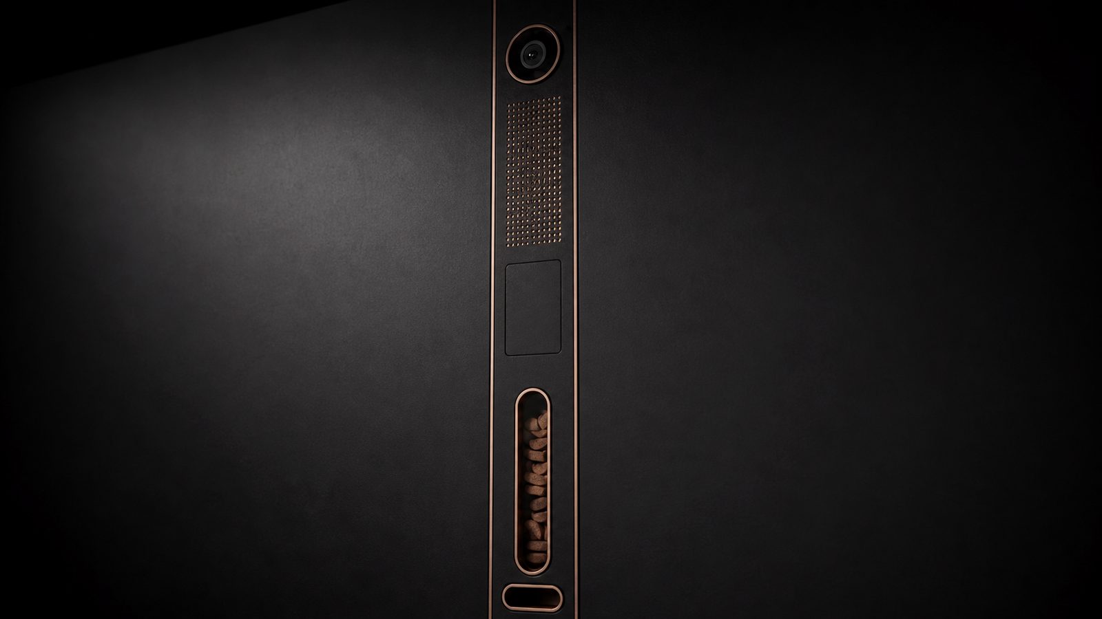 Macro photograph of the vertical Tech Bar camera, speaker grille, sensor panel, treat window, and drop slot